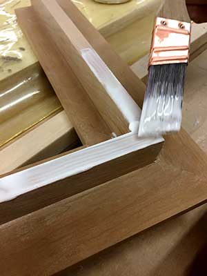 brushing-glue-cherry-hardwood-gilded-frame-prep